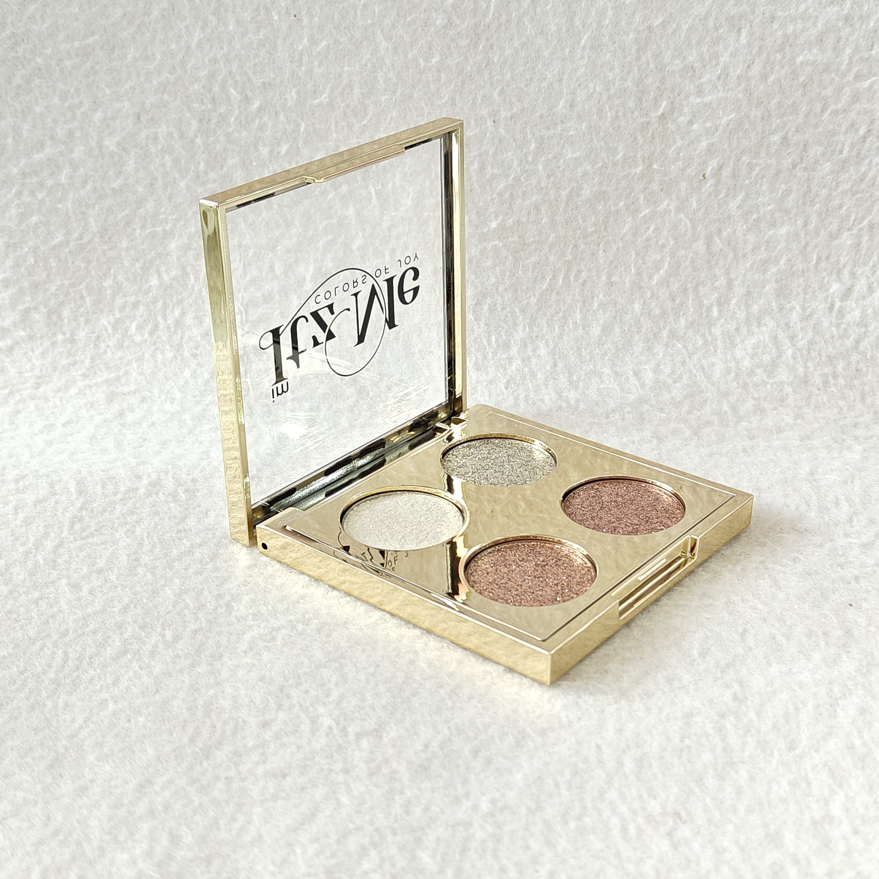 Hand holding Itz Me Shimmer Palette Shade 01 showing 4 metallic glitter colors in sleek packaging